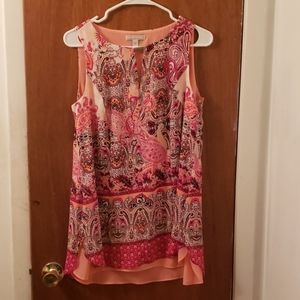 A pink blouse with a flowered design in the front